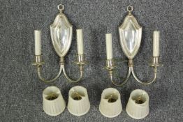 A pair of silver coloured wall lights with matching shades. Each measuring H.33 x W.25 cm.