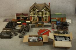 A 20th century tin plated model trainset together with assorted buildings, trains and track. H.58