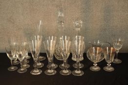 Assorted vintage glassware to include drinking glasses and two decanters and stoppers. H.40cm (