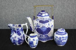 A collection of blue and white; a tea pot with three jars. Two lidded. With the makers seal on the