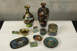 A collection of enamel pots and boxes with floral decoration. A mix of Persian, Japanese and Chinese