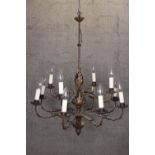 A large foliate chandelier with twelve branches of lights and decorative trunk. Complete with