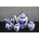 A collection of blue and white; a tea pot with three jars. Two lidded. With the makers seal on the