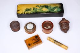 A collection of seven small lacquered and painted lidded boxes including a decorated pencil box. The