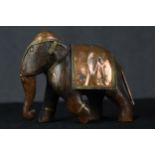 A carved hardwood elephant with copper decoration. The copper is highly detailed with beading to the