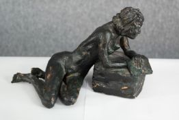 A bronze effect painted terracotta figure of a reclining nude. H.16 x W.29 cm.
