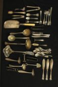 An assortment of silver plated cutlery and utensils of various styles and ages including nutcrackers