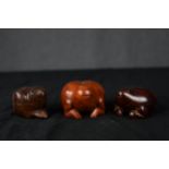 A set of three carved hardwood lidded pots in the shape of frogs. Twentieth century. H.4 x W.5.5 x
