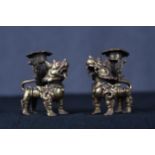 Two Chinese Foo dog or dragon gilt brass candle holders. Early twentieth century.