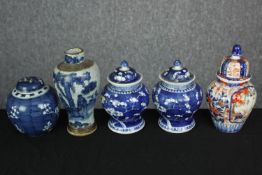 Five hand painted blue and white pots and another colour pot. Four lidded. Stamped on the base