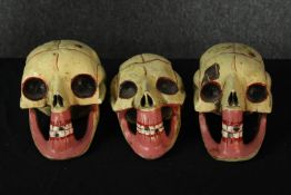 Three wooden carved skulls. Probably Mexican and early twentieth century. Hand painted and each