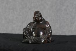 A Chinese hardwood Buddha. Twentieth century. H.18 x W.16 x D.12 cm.