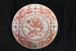 A nineteenth century Chinese hand painted porcelain bowl decorated with five clawed dragons