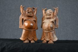 Two carved hardwood dancing Buddhas. Each measuring H.20 W.13 D.6 cm.