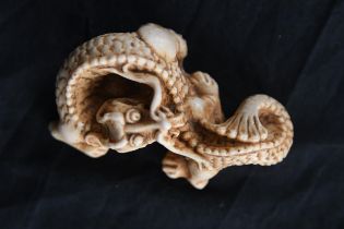 A Japanese moulded dragon. Twentieth century. H.4 x W.7.5 x D.5 cm