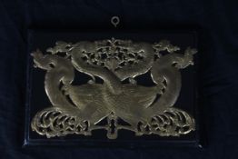 A Japanese brass plaque. Two entwined phoenix. H.15 x W.22 cm.