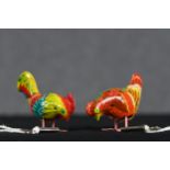 Two wind up toy chickens. Lithographed tin. Complete with their keys. H.6 W.10 D.4 cm.