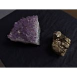 A large Amethyst crystal along with a piece of iron pyrites. The largest measures. H.6 W.10 D.10 cm.