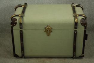 A vintage style travelling trunk with leather and wood bindings. H.48 W.78 cm.