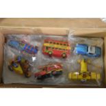 A assortment of tin and die-cast vehicles including a bus, train, fire engine and aeroplane.