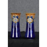 A pair of Royal Doulton vases. Floral decoration with a deep blue glaze. W.24 W.11 cm.