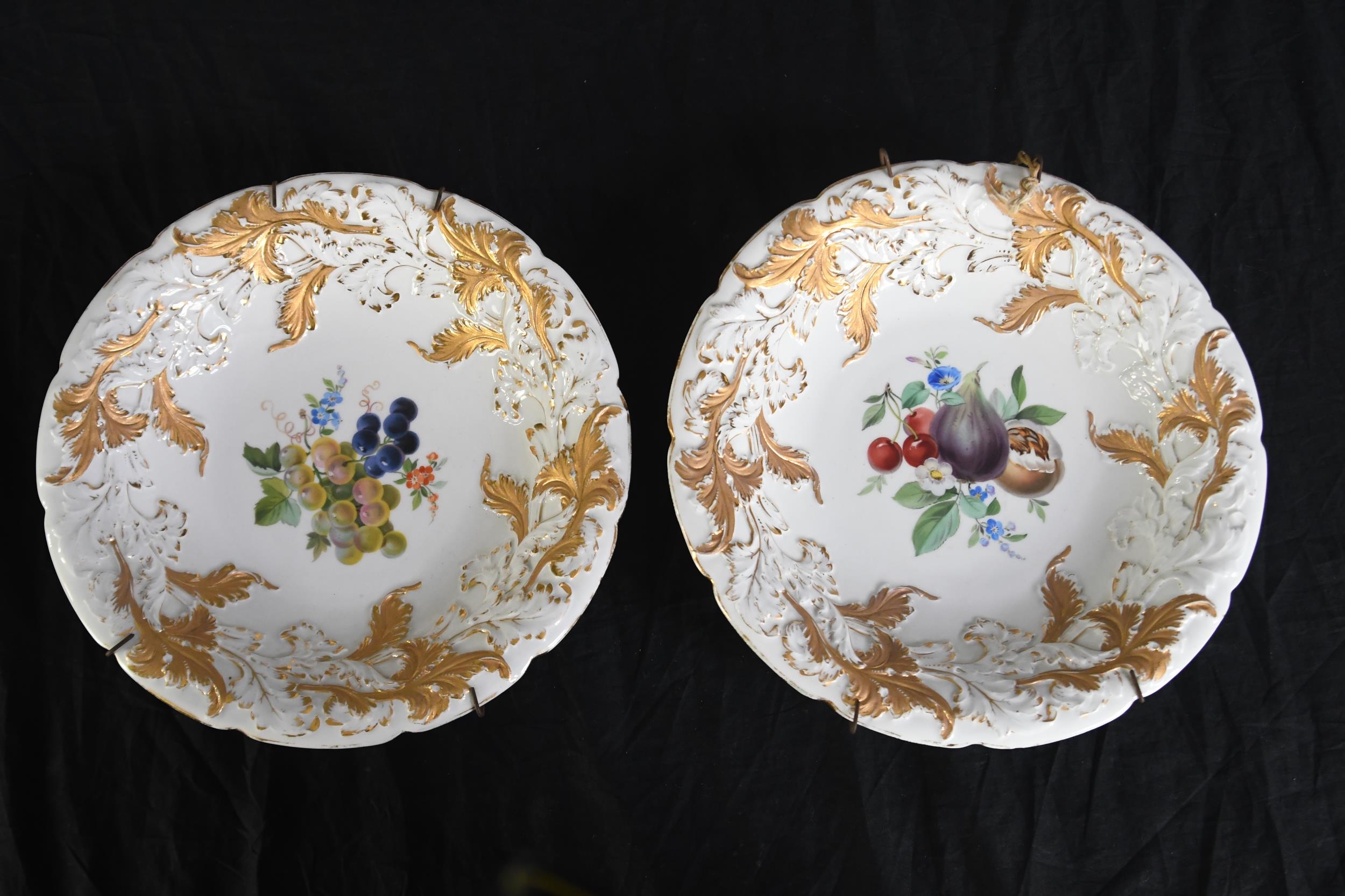 A pair of 19th century Meissen decorative ceramic plates with gilt relief and hand painted fruit and