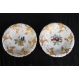 A pair of 19th century Meissen decorative ceramic plates with gilt relief and hand painted fruit and