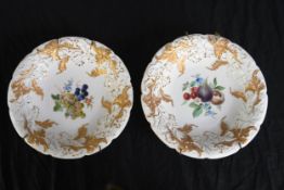 A pair of 19th century Meissen decorative ceramic plates with gilt relief and hand painted fruit and