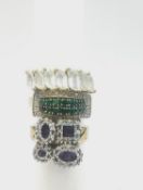 Three 9ct yellow gold rings, one set with amethyst and diamonds with abstract design, a emerald