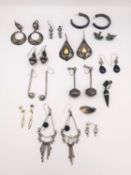A collection of twelve pairs of silver earrings, including lapis, turquoise, rainbow moonstone and