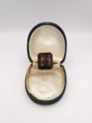 A 9ct yellow gold smokey quartz dress ring, set with a rectangular mixed cut smokey quartz with an