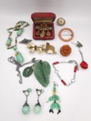 A collection of costume jewellery, including a carved amber Bakelite rose brooch, Czech glass flower