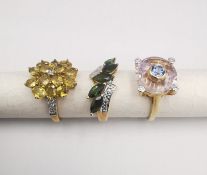 Three 20th century 9 carat gold gem-set rings, with certificates. A green tourmaline and diamond