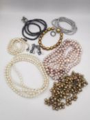 A collection of cultured pearl jewellery, including a very long knotted pink pearl necklace, a