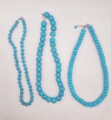 Three modern turquoise bead necklaces with silver clasps, including a large knotted barrel bead