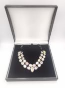 A boxed silver and mystic quartz set articulated collar necklace with silver chain section and