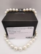 A boxed AAAAA top lustre white round Edison pearl necklace with platinum clasp. The necklace with