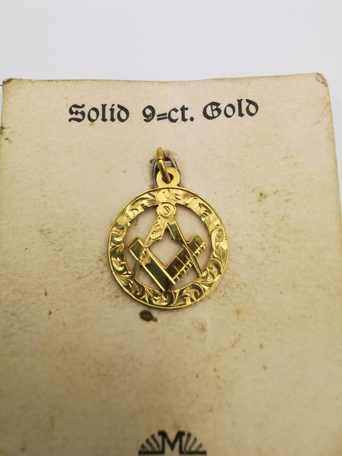 A 9ct yellow gold pierced and engraved masonic pendant with square and compasses. Stamped 9ct. - Image 2 of 3