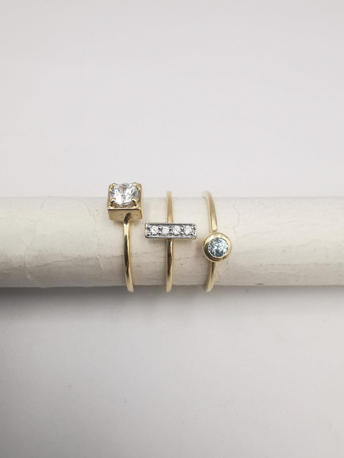 A 9ct yellow gold three part stacking ring set with blue and white zircon. Accompanied by - Image 2 of 3
