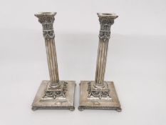 A pair of Dutch silver candlesticks with fluted column design, laurel wreath swag detailing on