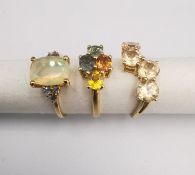 Three 20th century 9 carat gold gem-set rings with certificates: a rainbow sapphire ring, an opal