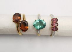 Three 20th century 9 carat gold gem-set rings. An amber stone crossover ring, a turquoise stone