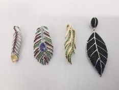Four gem set silver feather and leaf pendants, set with onyx, peridot, tanzanite, opal, rubellite