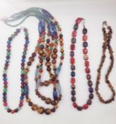 Four 20th century dyed agate and tiger's eye bead necklaces, including a very large three strand