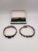 Two Victorian sprung mourning bracelets and a broken bracelet, one 9ct rose gold with carved black