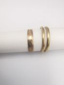 Three 9ct yellow gold bands and a yellow metal chilli charm. Various makers. Hallmarked:375.