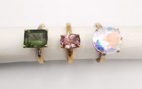 Three 20th century 9 carat gold gem-set rings, a pink tourmaline solitaire ring, a mystic topaz