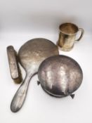 A collection of silver items, a silver hand mirror, a silver clothes brush, a circular engraved