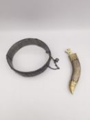 A silver Kukri brooch with removable dagger and gilded detailing to the sheath along with a white