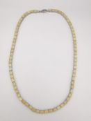 A silver Ethiopian opal set tennis necklace. Set wit seventy one oval mixed cut opals with a